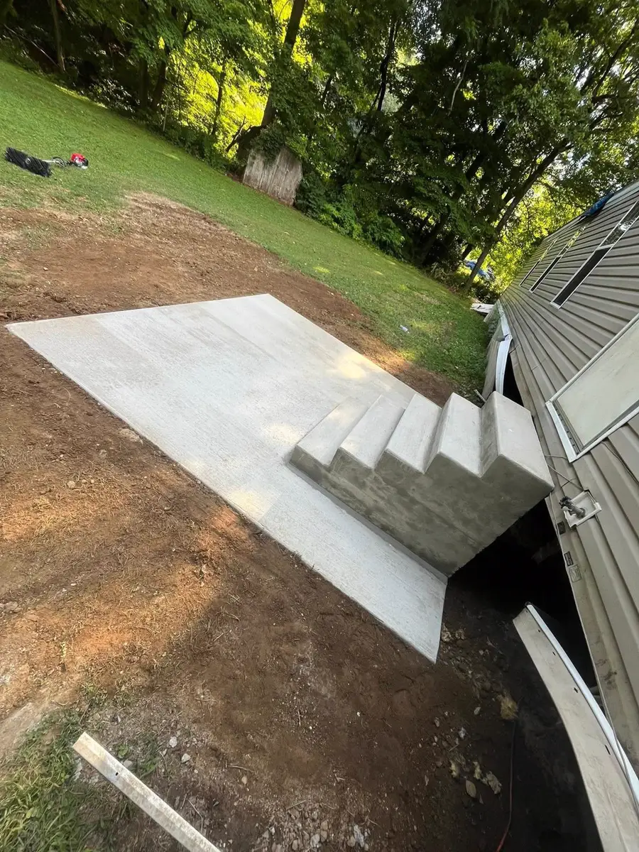 Steps and slab poured beside a shed